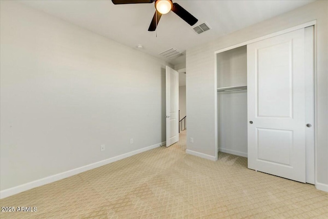 unfurnished bedroom with light colored carpet, a closet, and ceiling fan