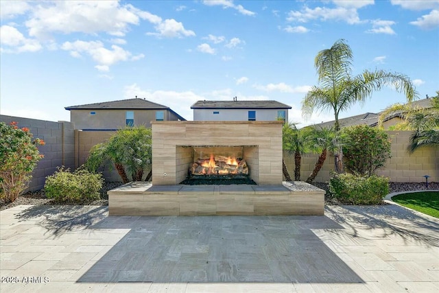 view of patio with a fireplace