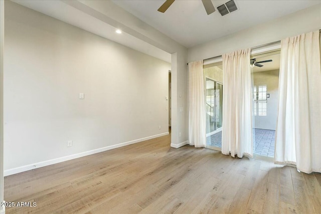 empty room featuring ceiling fan and light hardwood / wood-style floors