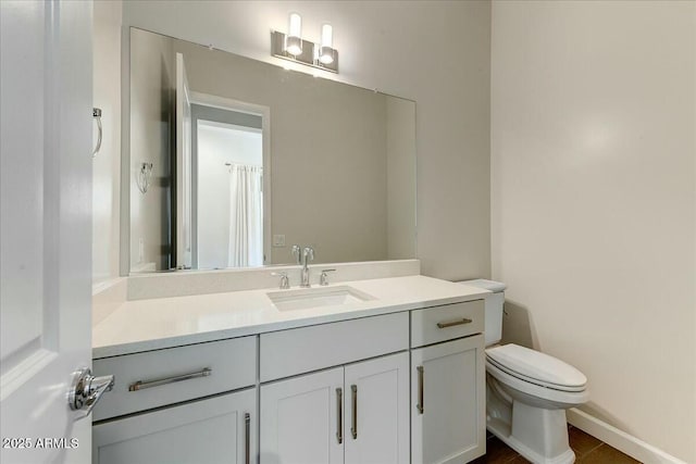 bathroom featuring vanity and toilet