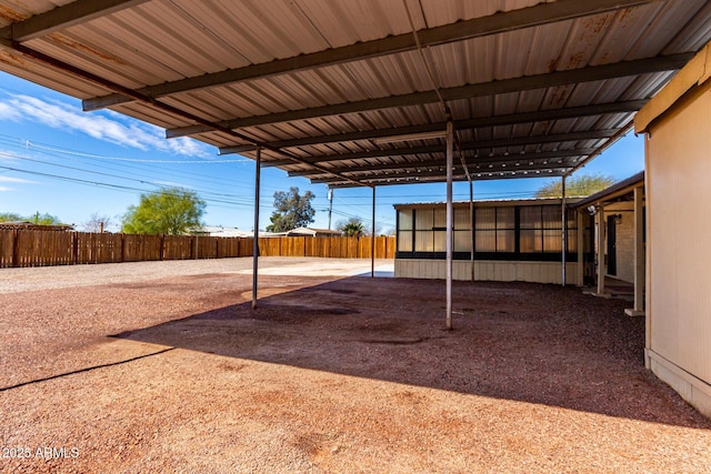 view of yard featuring a carport and fence