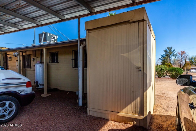 view of property exterior featuring water heater and central AC unit