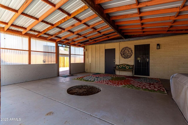 unfurnished sunroom featuring vaulted ceiling