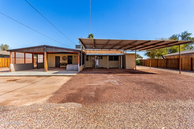 back of house with a carport and driveway