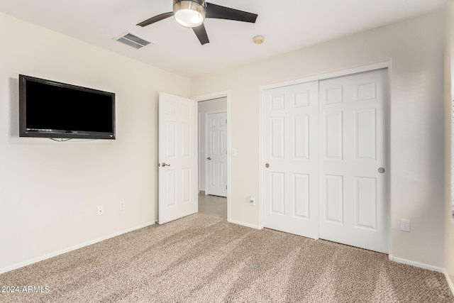 unfurnished bedroom featuring ceiling fan, carpet floors, and a closet