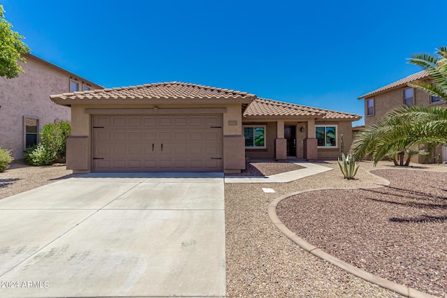 mediterranean / spanish-style home with a garage