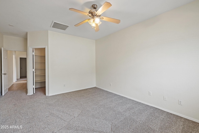 unfurnished bedroom featuring visible vents, carpet, baseboards, and a spacious closet