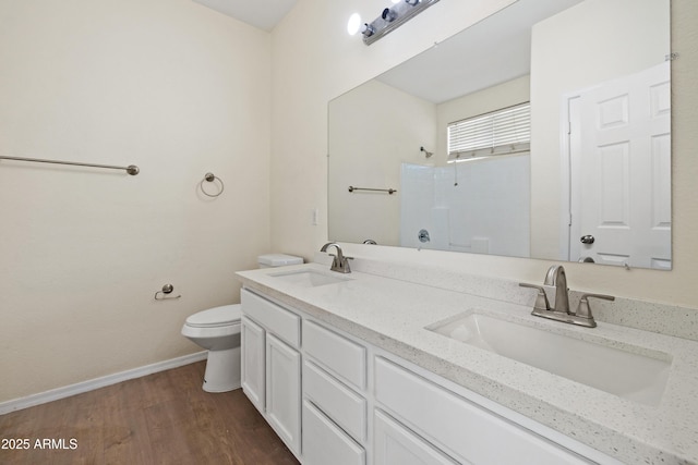 bathroom with a sink, toilet, a shower, and wood finished floors