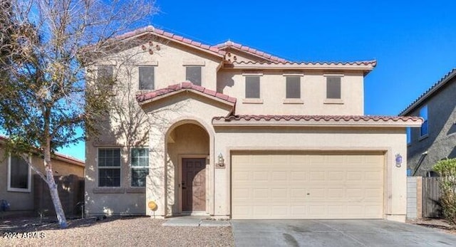 mediterranean / spanish-style house with a garage