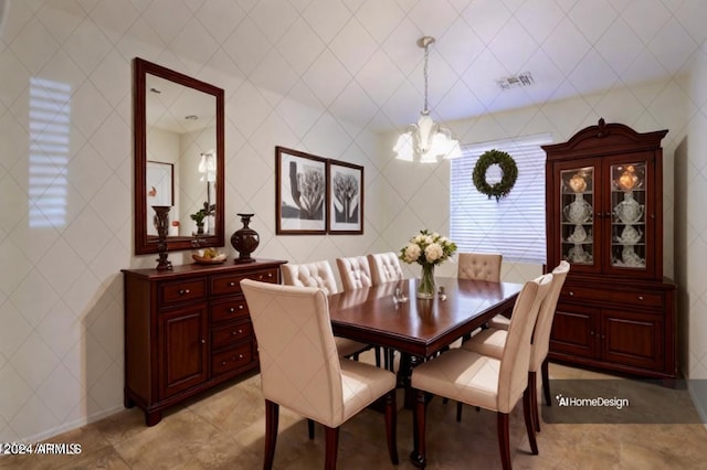 dining space featuring tile walls and a notable chandelier