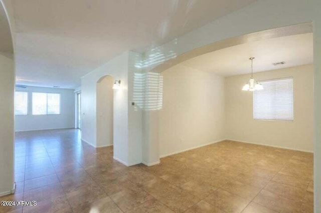 empty room featuring a chandelier