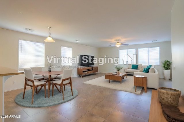 dining space featuring light tile patterned flooring and ceiling fan