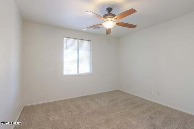 unfurnished room featuring ceiling fan and light colored carpet