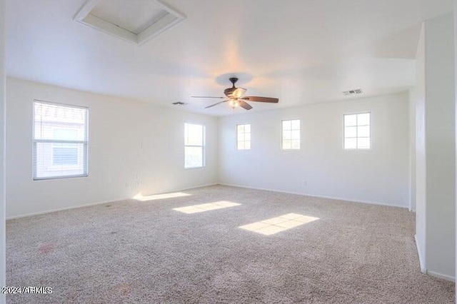 spare room with ceiling fan and light colored carpet