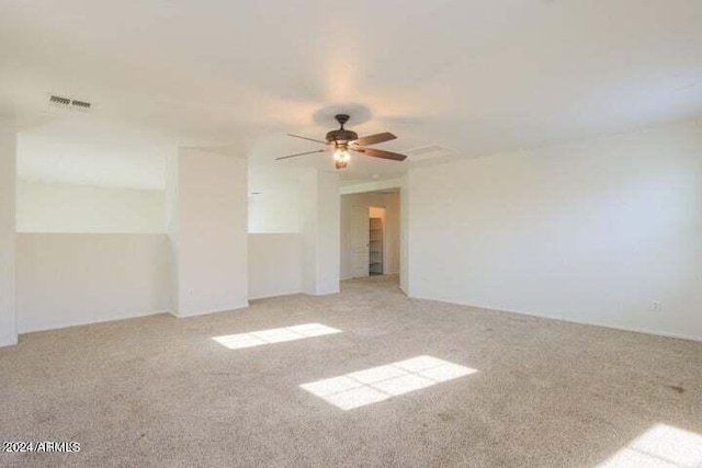 unfurnished room with ceiling fan and light colored carpet