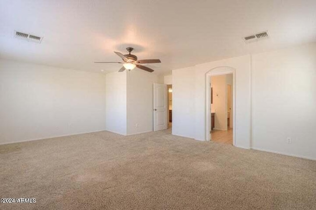 carpeted empty room featuring ceiling fan