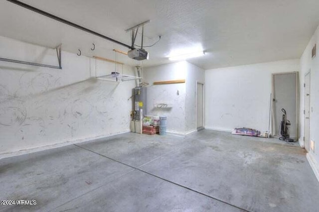 garage featuring a garage door opener and water heater