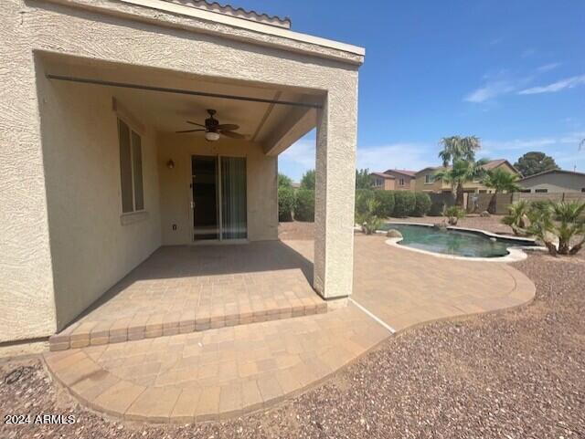 exterior space with ceiling fan and a patio