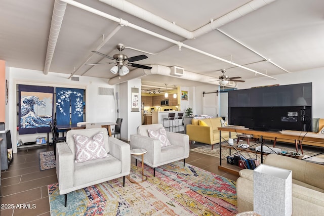 living room with ceiling fan, visible vents, and tile patterned floors