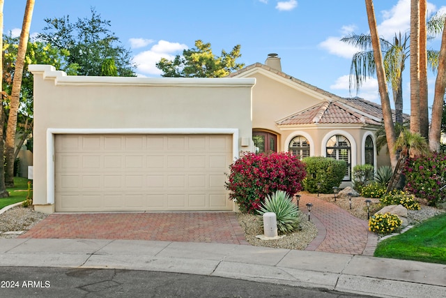 mediterranean / spanish house featuring a garage