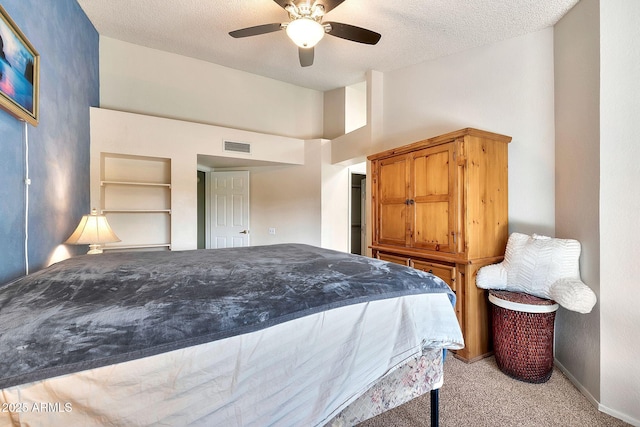 carpeted bedroom featuring a textured ceiling and ceiling fan