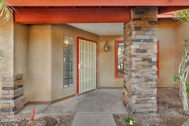 doorway to property with a patio area