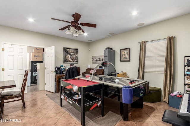 office area with ceiling fan and light tile patterned flooring