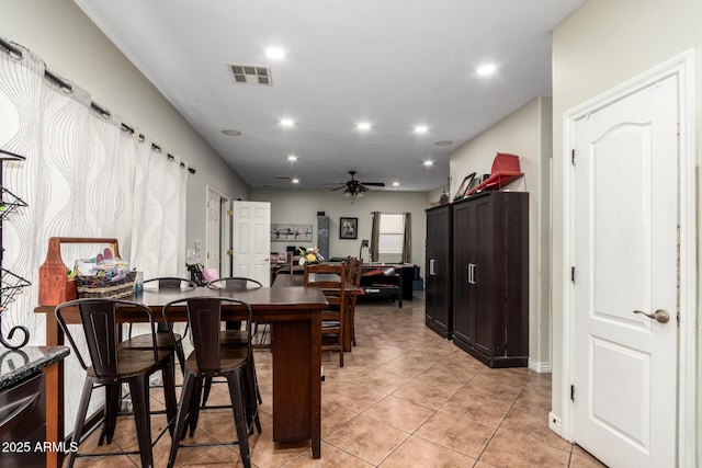 tiled dining room with ceiling fan