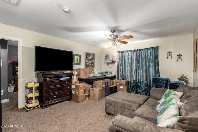 carpeted living room with ceiling fan and a textured ceiling