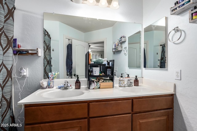 bathroom featuring ceiling fan and vanity