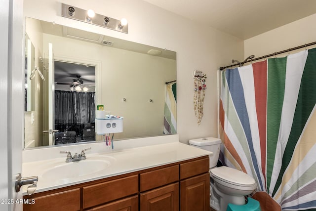 bathroom featuring toilet, vanity, ceiling fan, and a shower with shower curtain