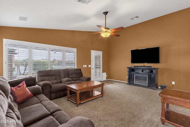 11101 W Wilshire Dr, Avondale, AZ 85392 - carpeted living room featuring ceiling fan, a fireplace, high vaulted ceiling, and baseboards