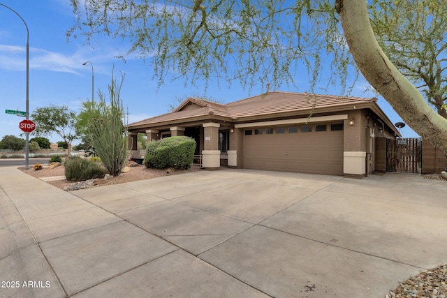 11101 W Wilshire Dr, Avondale, AZ 85392 - view of front of property with a tiled roof, stucco siding, a garage, driveway, and a gate