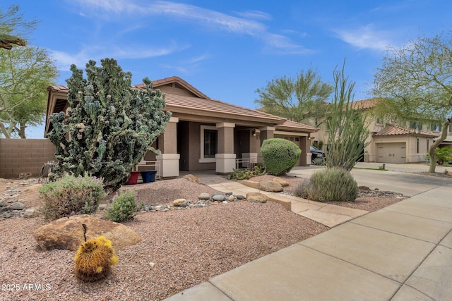 11101 W Wilshire Dr, Avondale, AZ 85392 - view of front facade with a tile roof, fence, stucco siding, and driveway