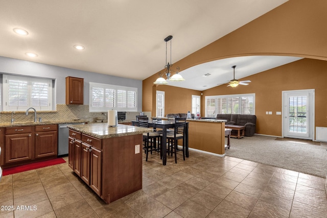 11101 W Wilshire Dr, Avondale, AZ 85392 - kitchen with a sink, stainless steel dishwasher, lofted ceiling, open floor plan, and a center island