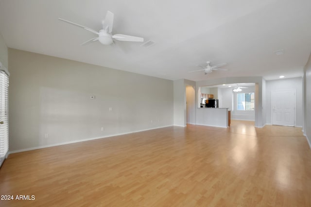 unfurnished living room featuring light wood-type flooring and ceiling fan