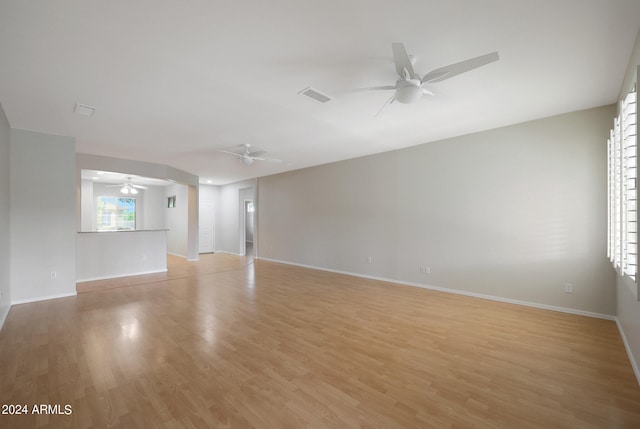 empty room with ceiling fan and light wood-type flooring