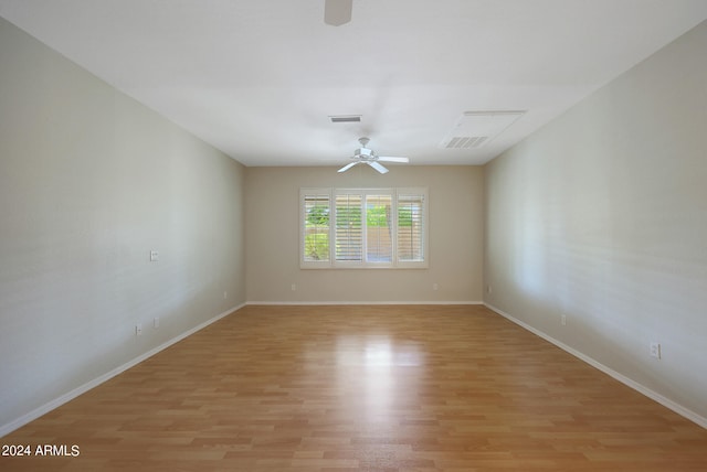 spare room featuring light hardwood / wood-style flooring and ceiling fan