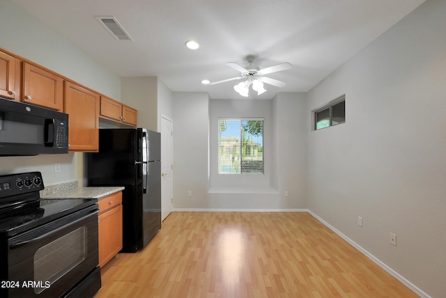 kitchen featuring black appliances, light hardwood / wood-style flooring, and ceiling fan