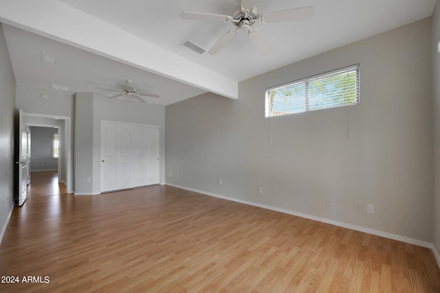 empty room with light hardwood / wood-style floors, ceiling fan, and beam ceiling