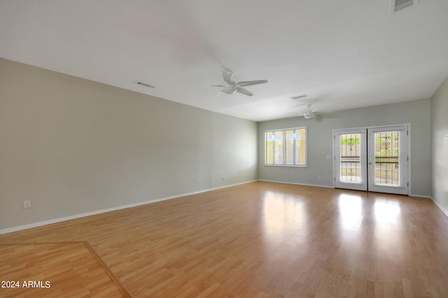 unfurnished room with light wood-type flooring and ceiling fan