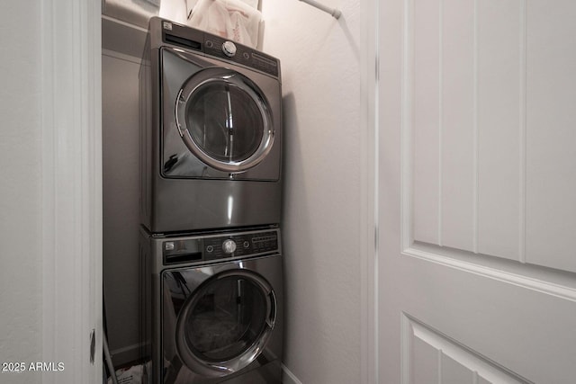 laundry room featuring laundry area and stacked washer / drying machine