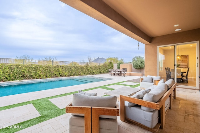 view of patio / terrace featuring a fenced in pool, outdoor dining area, fence, and an outdoor living space