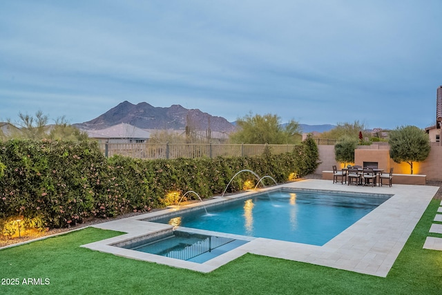 view of pool featuring an in ground hot tub, a fenced backyard, a mountain view, and a patio