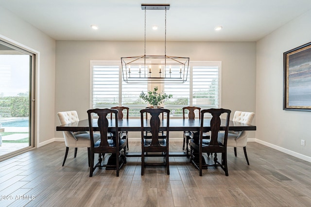 dining area with plenty of natural light, baseboards, and wood finished floors