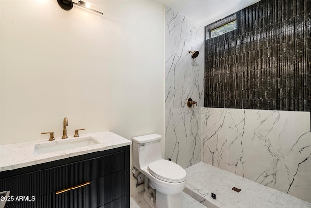 bathroom with vanity, a marble finish shower, and toilet