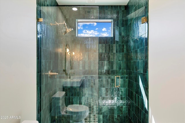 bathroom with toilet and a shower stall