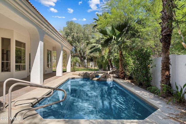 view of pool with a fenced backyard, a patio area, and a pool with connected hot tub