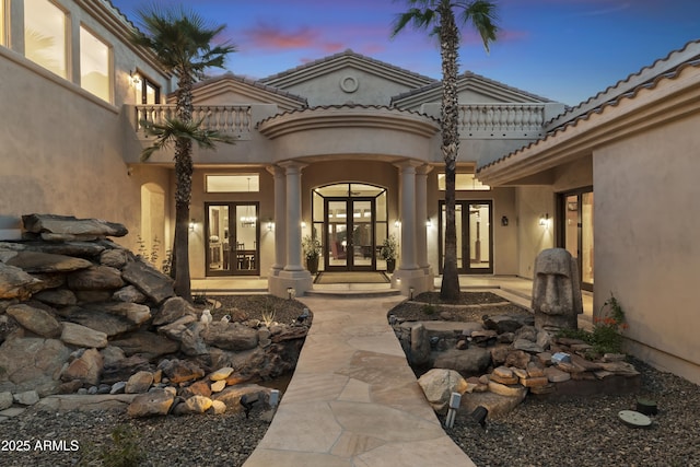 exterior entry at dusk with french doors