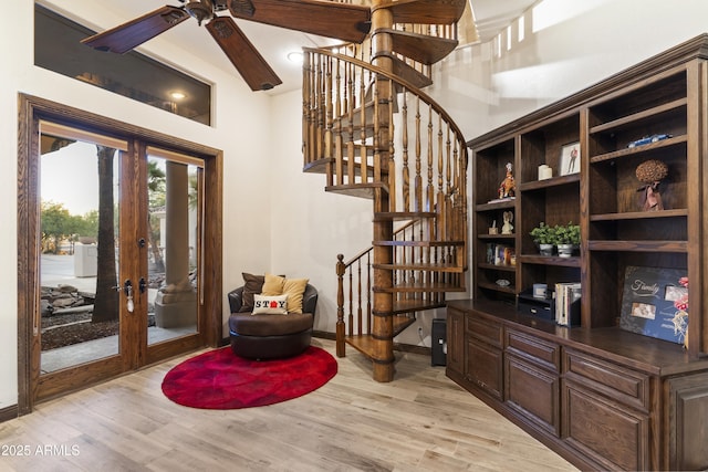 interior space featuring french doors, dark brown cabinetry, and light wood-type flooring